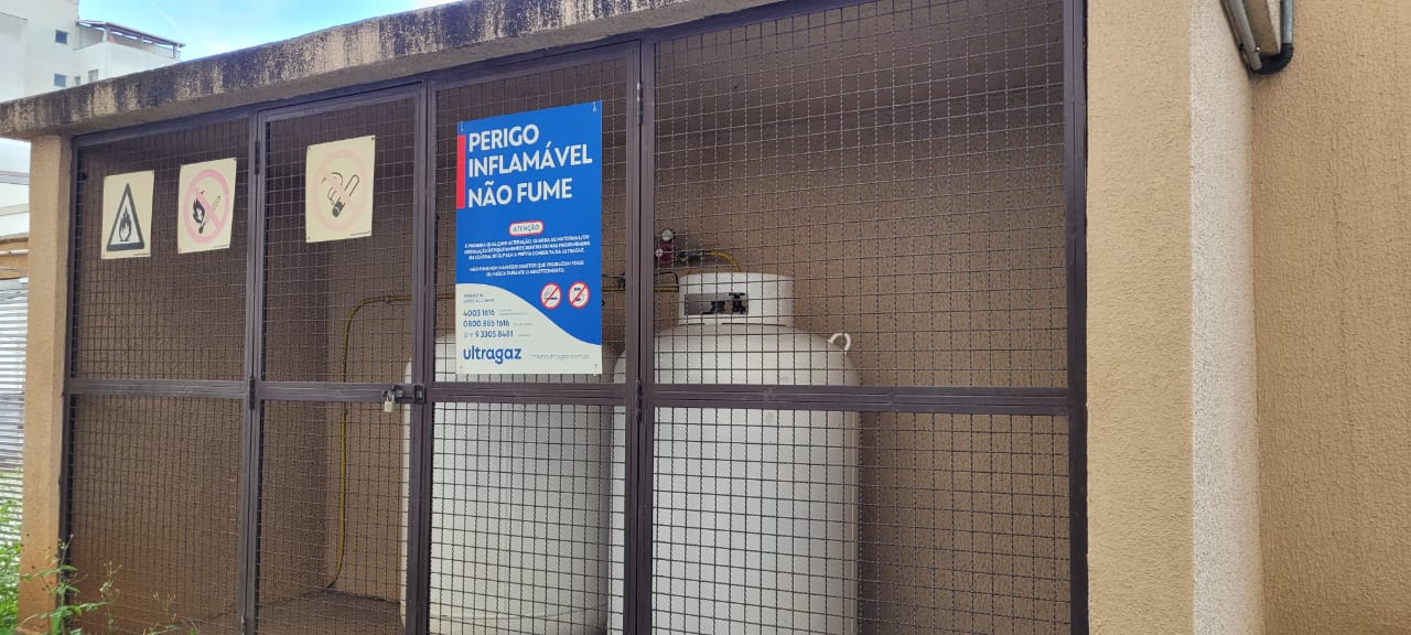 Central de gás em abrigo gradeado com cilindros e reguladores